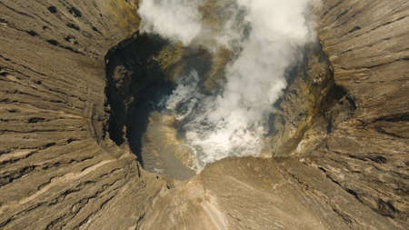 Crater with active volcano smoke in East Jawa, Indonesia. Aerial view of volcano crater Mount Gunung...