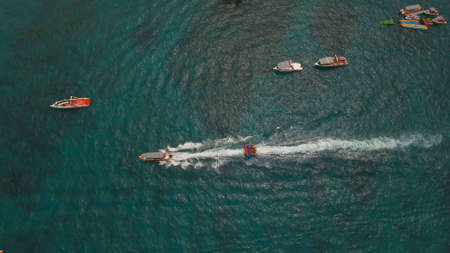 People having fun on banana boat. Group of people riding banana boat. Philippines, Boracay. Travel concept.の写真素材