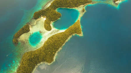Aerial view: Bucas Grande Island, Sohoton Cove. Philippines. Tropical sea bay and lagoon, beach. Tropical landscape hill, clouds and mountains rocks with rainforest. Azure water of lagoon. Shore Landscape Bay. Aerial video.Seascape. Travel concept.の写真素材
