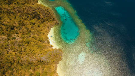 Aerial view: Lagoon with blue, azure water in the middle of small islands and rocks. Beach, tropical island, sea bay and lagoon, mountains with forest, Palawan, Coron. Busuanga. Seascape, tropical landscape. Philippines. Travel conceptの写真素材