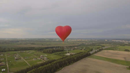 Hot air balloon shape of a heart in the blue sky. Aerostat, Airship. Red balloon.の写真素材