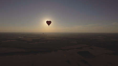Hot air balloon shape of a heart in the blue sky. Aerostat, Airship. Red balloon.の写真素材