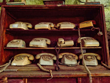 Antique street shop with old telephones in Bali.の写真素材