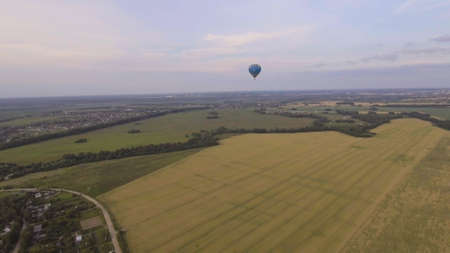 Aerial view Hot air balloons in the sky over a field in the countryside in the beautiful sky and...