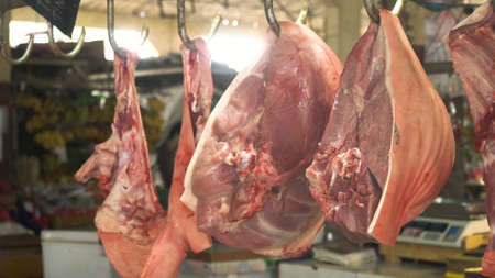 Meat in a street market. Meat from Asian market. Heap of fresh raw meat food flesh background at...