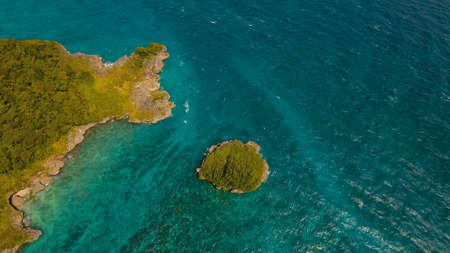 Aerial view of beautiful tropical island with with azure water,Boracay. Tropical lagoon with turquoise water. Beautiful tropical island. Seascape: Beautiful view of the island, rock in the sea from the air. Philippines, Travel concept.の写真素材