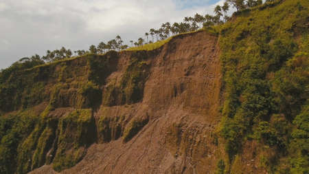 Landslides and rockfalls on the road in the mountains, Camiguin. Aerial view: mud and rocks blocking...