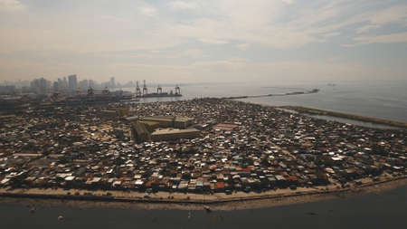 Aerial view poor district of Manilas slums, ghettos, wooden old houses, shacks. Slum area of Manila,...