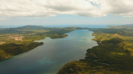 Seascape with a tropical bay surrounded by mountains on the island. Aerial view: Beautiful tropical...