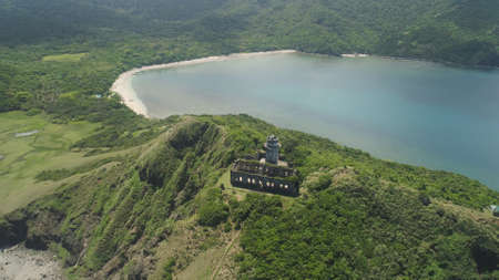 Aerial view of lighthouse in Palau island. Lighthouse in cape Engano against blue sky, province of Cagayan, Philippines.の写真素材