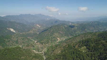 Aerial view of rice terraces and agricultural farm land on the slopes of mountains valley....