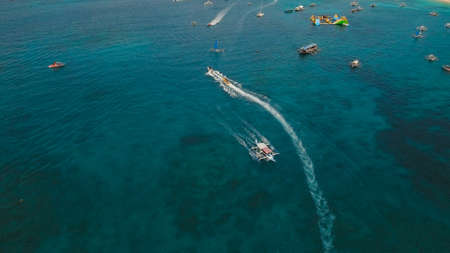 People having fun on banana boat. Group of people riding banana boat. Philippines, Boracay. Travel...