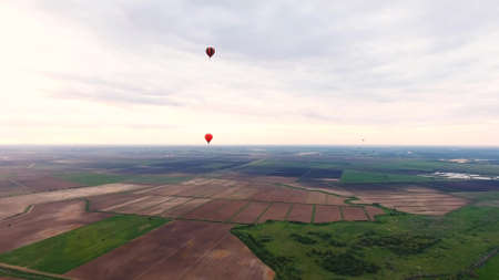 Aerial view Hot air balloons in the sky over a field in the countryside in the beautiful sky and sunset. Aerostat fly in the countryside.の写真素材