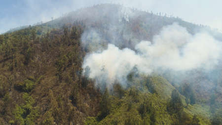 fire in mountain forest. fire and smoke on slopes hills. aerial view wild fire in mountains in...