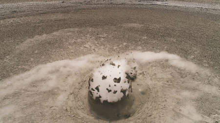 Mud volcano with bursting bubble bledug kuwu. aerial view volcanic plateau with geothermal activity...