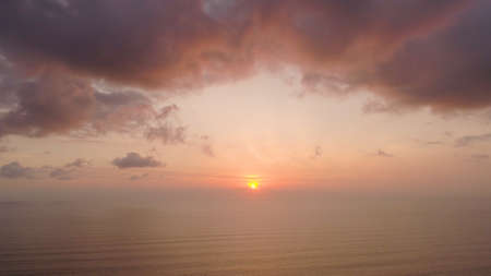 aerial view sunset over ocean. seascape. colorful sunset over sea in tropics. Flying over surface sea at sunset. aerial seascape ocean surface. Travel conceptの写真素材