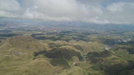 Aerial view of mountains covered with green vegetation, valley, trees in vicinity volcano Pinatubo....