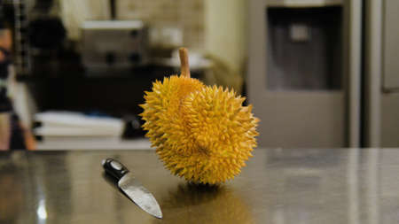 ripe durian cooked for cutting with a knife on the kitchen table in the restaurant
