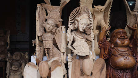 Hindu and Buddhist wooden carving. souvenir shop selling souvenirs and handicrafts of Bali at famous Ubud Market, Indonesiaの写真素材