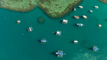 Many boats in the turquoise lagoon, view from above.Seascape with blue bay and boats. traditional Filipino wooden outrigger boat called a banca. Summer and travel vacation conceptの写真素材