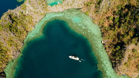 Aerial tropical landscape blue lagoon surrounded by rocks on tropical island. Seascape, tropical...