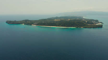 Tropical island Boracay with sandy beach and hotels view from the sea, aerial view. Summer and...