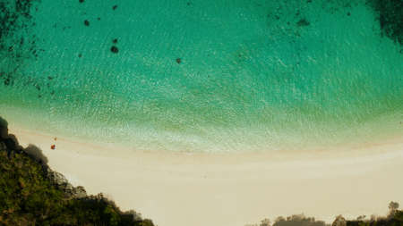 Tropical sandy beach with wave and turquoise water,copy space for text, aerial view. Ocean with...