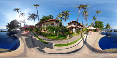 vr 360 swimming pool in luxury hotel with sun beds by sea. tropical resort with pool. Travel concept.の写真素材