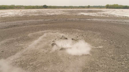 Mud volcano with bursting bubble bledug kuwu. aerial view volcanic plateau with geothermal activity...