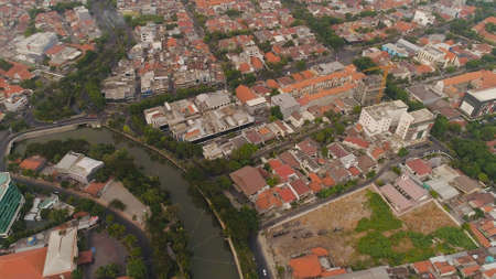 Aerial cityscape modern city Surabaya with skyscrapers, buildings and houses. sunset in city skyline...