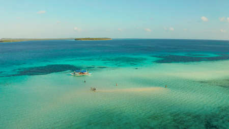 Sand bar among coral reefs in turquoise atoll water, top view. Summer and travel vacation concept. Balabac, Palawan, Philippines.の写真素材