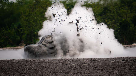 mud volcano with bursting bubble bledug kuwu. volcanic plateau with geothermal activity and geysers, slow motion Indonesia java. volcanic landscapeの写真素材