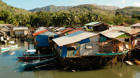 Coron city with slums and poor district. Old wooden house standing on the sea in the fishing...