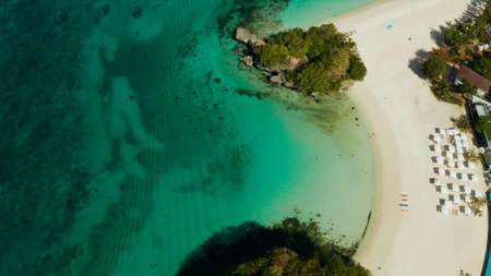 Tropical beach with luxury hotels and turquoise lagoon aerial view, Boracay, Philippines. White sandy beach with tourists and hotels. Seascape with beach on tropical island. Summer and travel vacation concept.の写真素材