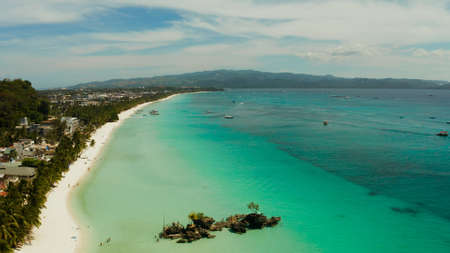 White sand beach and Willys rock with tourists and hotels and sailing boat, aerial view. Boracay, Philippines. Summer and travel vacation concept.の写真素材