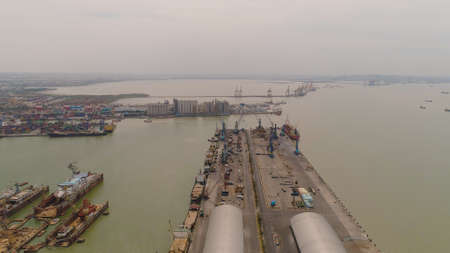 aerial view cargo and passenger seaport with ships and crane Tanjung Perak, surabaya, indonesia. docks for the repair and parking of ships, cargo port and container terminal. ship in industrial portの写真素材