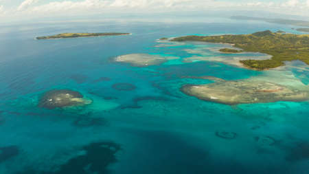 Islands are surrounded by an atoll and a coral reef with blue water top view. Bucas grande, Philippines. Summer and travel vacation concept.の写真素材