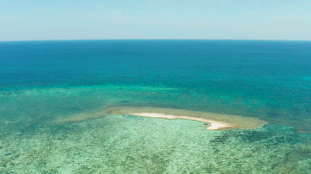 Sand bar among coral reefs in turquoise atoll water, top view. Summer and travel vacation concept....