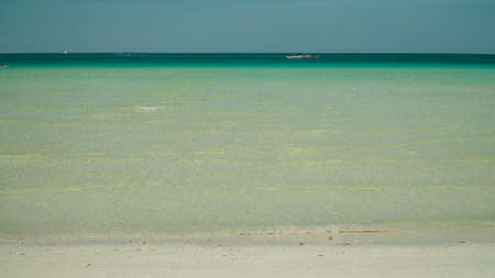 Tropical beach and turquoise lagoon in front of blue sky. Boracay, Philippines. Summer and travel...