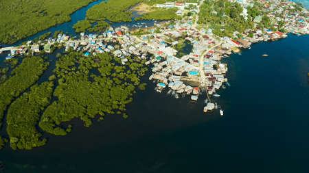Village near mangroves in the bay of the ocean, top view. Siargao island, Philippines.の写真素材