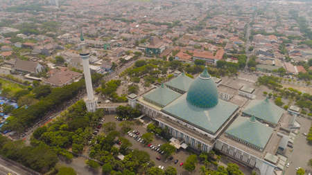 aerial view cityscape city Surabaya with mosque Al Akbar, highway, buildings and houses. mosque in Indonesia Al Akbar in Surabaya, Indonesia. beautiful mosque with minarets on island Java Indonesia.の写真素材