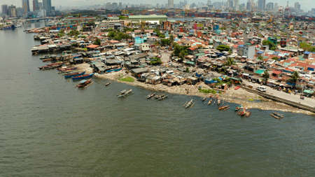 Manila is the capital of the Philippines with slums and poor district and skyscrapers and modern buildings.の写真素材