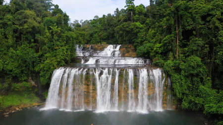 Beautiful waterfall in green forest, top view. Tropical Tinuy-an Falls in mountain jungle,...