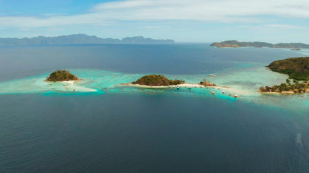 aerial seascape bay with tropical island and sand beach, turquoise water and coral reef. Bulog Dos, Philippines, Palawan. tourist boats on coast tropical island.の写真素材