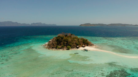 Aerial drone tourists enjoy tropical beach. tropical island and sand beach, turquoise water and coral reef. malacory island, Philippines, Palawan. tourist boats on coast tropical island.の写真素材