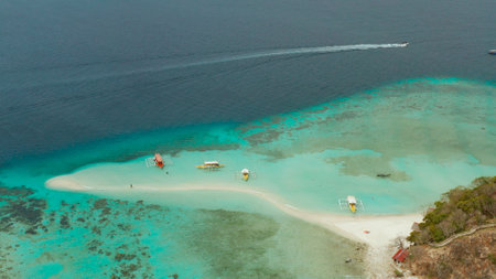 aerial seascape tropical island and sand beach, turquoise water and coral reef. malacory island,...