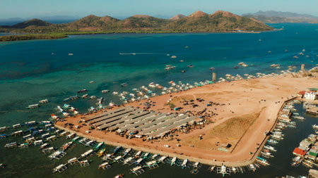 aerial view Coron City, tourist destination in the Philippines.Pier and promenade Coron town with boats on Busuanga island. Wooden boats waiting at pier. Seascape with mountains. Philippines, Palawanの写真素材