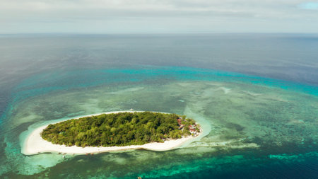 Tropical island and sandy beach surrounded by atoll and coral reef with turquoise water, aerial drone. Tropical island and coral reef. Summer and travel vacation concept, Camiguin, Philippines, Mindanaoの写真素材