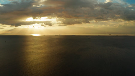 Dramatic sunset over Manila Bay with ships and cargo ships, top view. Summer and travel vacation conceptの写真素材