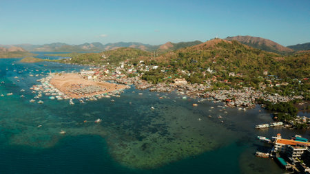 aerial view Coron City, tourist destination in the Philippines.Pier and promenade Coron town with boats on Busuanga island. Wooden boats waiting at pier. Seascape with mountains. Philippines, Palawanの写真素材